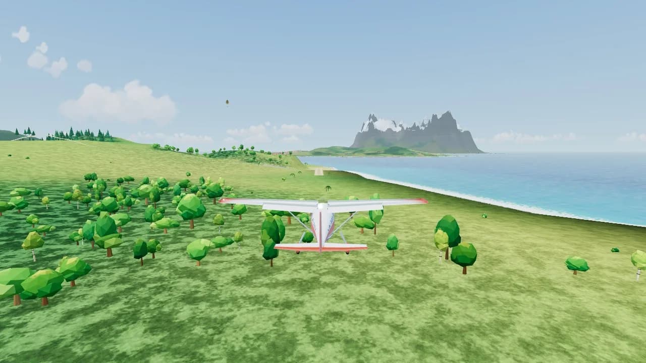 A little trainer plane flying low over green hills and trees towards a grass strip, with a snowy island across the sea