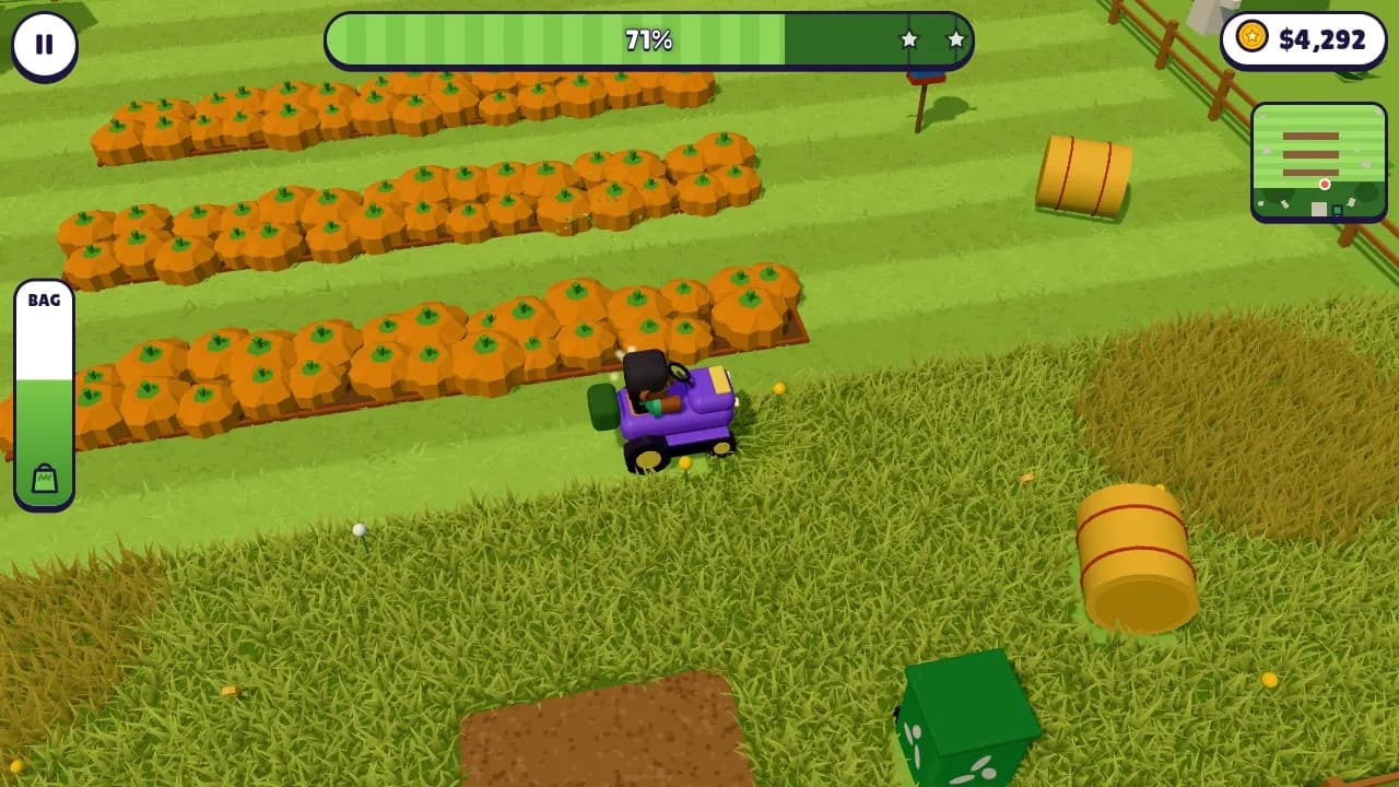 A purple ride-on mower steering round the pumpkin rows of the Halloween pumpkin patch