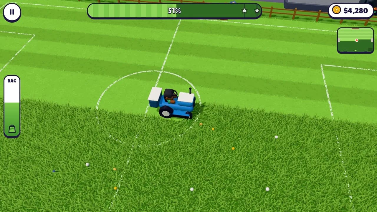 A blue lawn tractor mowing the Rovers soccer pitch, with the white pitch lines showing through the cut grass